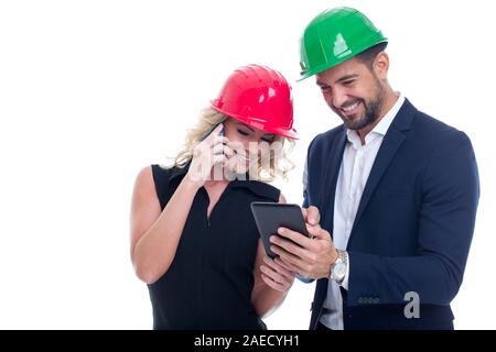 Young woman engineer calling, co-worker showing data on tablet, using mobile wireless communication devices, isolated on white Stock Photo