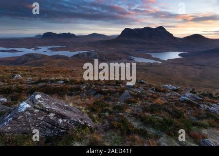 Cul Mor and Suilven mountains at dawn as seen from the slopes of Stac Pollaidh in Assynt in the Northwest Highlands of Scotland Stock Photo