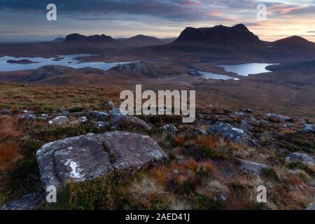 Cul Mor and Suilven mountains at dawn as seen from the slopes of Stac Pollaidh in Assynt in the Northwest Highlands of Scotland Stock Photo