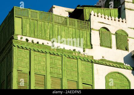 View of the famous greenish Noorwali coral town house at the Souk al Alawi Street in the historic city center of Al Balad, Jeddah, Saudi Arabia Stock Photo