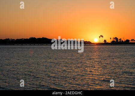 Scenic sunset with silhouettes of palm trees along the shore, seen from the South Corniche in Jeddah, Saudi Arabia Stock Photo