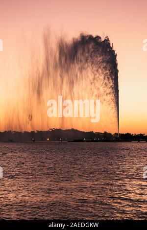 View of the King Fahd's Fountain seen from the South Corniche, Jeddah, Saudi Arabia, with a beautiful sunset in the background Stock Photo