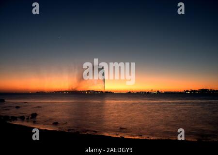 View of the King Fahd's Fountain seen from the South Corniche, Jeddah, Saudi Arabia, with a beautiful sunset in the background Stock Photo