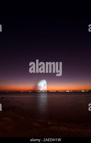 View of the King Fahd's Fountain seen from the South Corniche, Jeddah, Saudi Arabia, with a beautiful sunset in the background Stock Photo