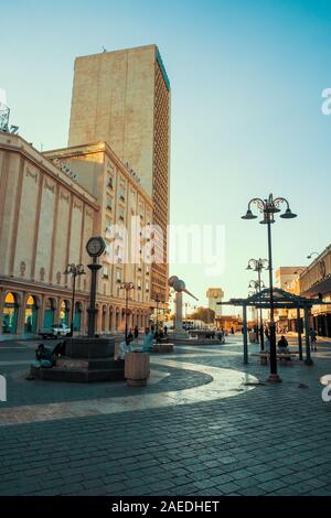 Scenic sunset view of the square next to the Bugshan Tower and the Al Mahmal Center at the Corniche in Al Balad, Jeddah, KSA, Saudi Arabia Stock Photo