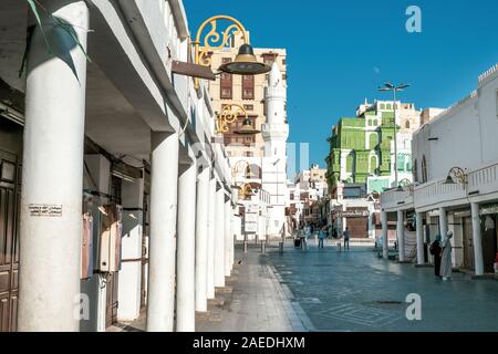 View of the Souk al Alawi Street, the greenish Noorwali coral town house and the Al Ma'amar Mosque at the historic district Al Balad in Jeddah, KSA Stock Photo