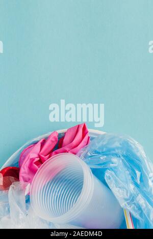 Top view of various kinds of disposable plastic waste on blue background, copy space Stock Photo