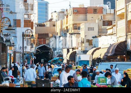 View of Arabic people bustling through the Souk Baab Makkah street market at the historic district Al Balad in Jeddah, KSA, Saudi Arabia Stock Photo