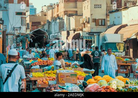 View of Arabic people bustling through the Souk Baab Makkah street market at the historic district Al Balad in Jeddah, KSA, Saudi Arabia Stock Photo