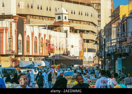 View of Arabic people bustling through the Souk Baab Makkah street market at the historic district Al Balad in Jeddah, KSA, Saudi Arabia Stock Photo