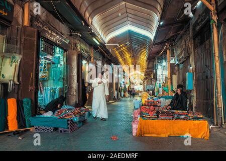 View of women sell textiles at the roofed section of the Souk Baab Makkah street market at the historic district Al Balad in Jeddah, KSA, Saudi Arabia Stock Photo