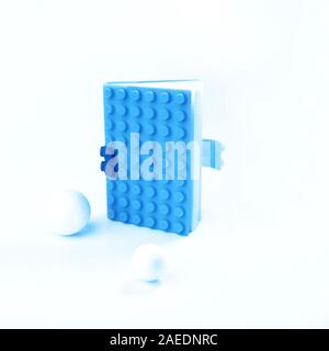 Creative layout made of bright blue notebook with white balls around. Still life, business, office supplies or education school concept. Classic Blue color 2020 inscription. Copy space. Stock Photo