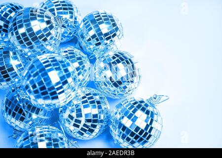 Blue color 2020 inscription. Creative pattern made of silver disco balls for decoration party on pastel blue gradient background. Winter New Years Party holiday concept. top view, flat lay close up. Stock Photo
