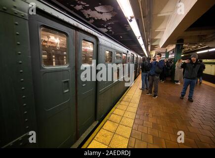 New York, USA. 8th Dec, 2019. People take photo of a vintage subway car during Holiday Nostalgia Rides in New York's subway, the United States, Dec. 8, 2019. Every Sunday between Thanksgiving and New Year, vintage 1930s R1-9 train cars would be placed in regular New York City subway service on specific routes during the annual Holiday Nostalgia Rides, taking passengers back into old times. Credit: Wang Ying/Xinhua/Alamy Live News Stock Photo