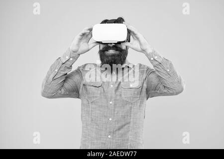 Impressive visual effects. Cyber sport. Augmented reality. Game development. Digital technology. Living alternative life. Hipster play video game. Bearded man explore vr. Gamer concept. Gaming hobby. Stock Photo