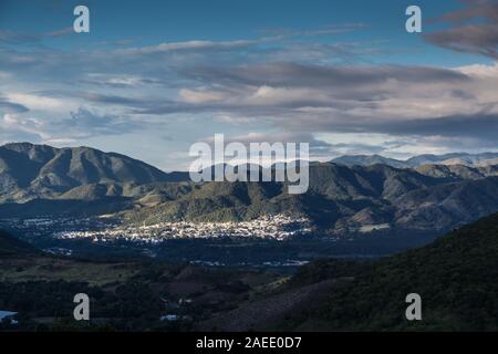 dramatic sunrise of a small town hit by sunlight in the mountains of the dominican republic. Stock Photo