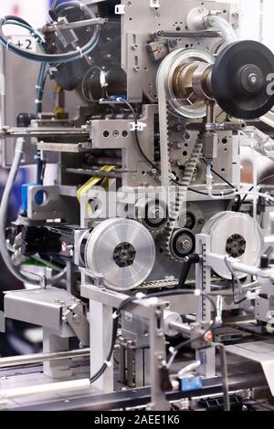 Detail view of a pharmaceutical packaging machine. Selective focus. Stock Photo