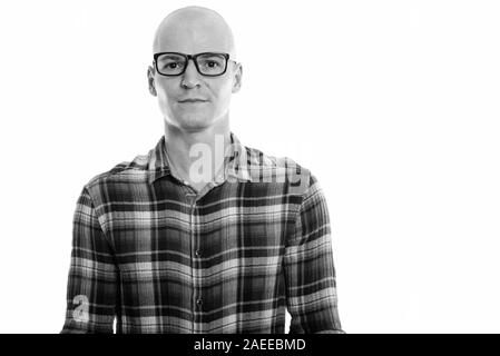 Studio shot of young handsome bald man wearing eyeglasses Stock Photo