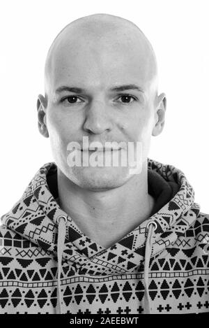 Studio shot of young handsome bald man wearing hoodie Stock Photo