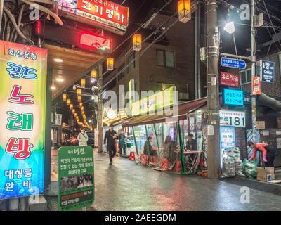 People in night street,  restaurants, coloured lights, Gyeongbokgung, Seoul, South Korea Stock Photo