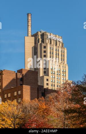 Philadelphia, Pennsylvania - November 25, 2019: Highrise buildings in Philadelphia, Pennsylvania, downtown. Skyscrapers on blue sky with a fall tree o Stock Photo