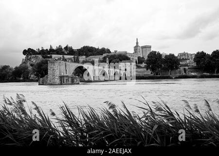 The Pont d'Avignon spanning part way across the Rhone River as a storm approaches in Avignon France Stock Photo