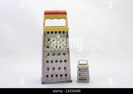 A large grater and a small grater isolated on a clear surface image in horizontal format with copy space Stock Photo