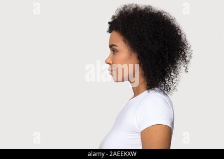 Young attractive African American woman standing in profile isolated Stock Photo
