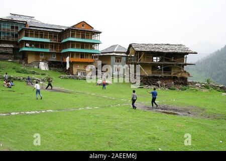 Children playing cricket, Sarchi Village, Tirthan Valley, Himachal Pradesh, India, Asia Stock Photo