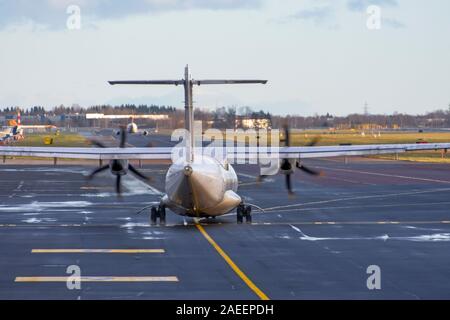 Aircraft turboprop taxiing on the runway airport Stock Photo