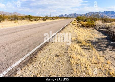Remote, long, straight road going into the Mojave Desert, California, USA Stock Photo