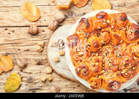Pumpkin buns with nuts and brown sugar.Cinnamon rolls or cinnabon Stock Photo