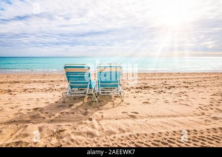 Two empty beach chairs on the beach of Hollywood in Fort Lauderdale, Florida. Stock Photo