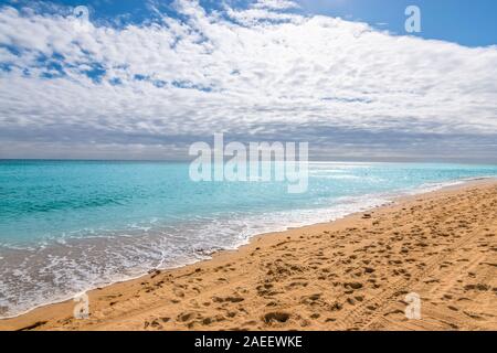 Hollywood beach with calm turquoise colored ocean, cloudy sky and reflection of the sun into the sea, Fort Lauderdale, Florida. Stock Photo