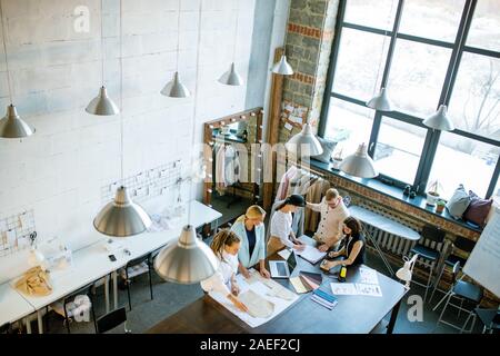 Group of young contemporary creative designers working over new collection Stock Photo