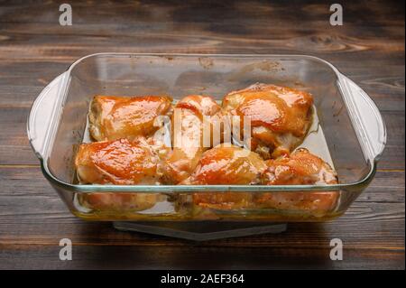 Homemade baked chicken thighs with soy sauce and spices in a glass tray. Copy space Stock Photo