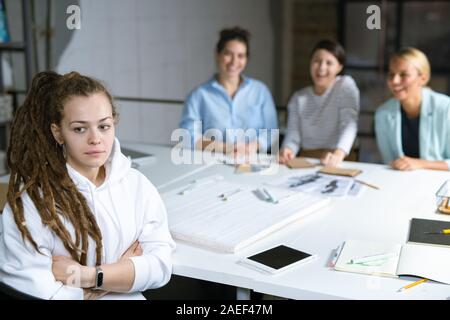 Young offended student or businesswoman suffering from her friends moaning Stock Photo