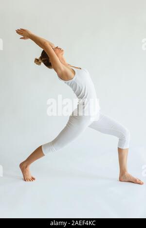 blonde cheerful woman doing yoga asanas. Healthy lifestyle and sport concept Stock Photo