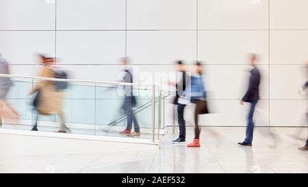 Many anonymous business people go out of business office after work Stock Photo