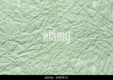 Crumpled paper texture in light green color for your best greeting card. Stock Photo