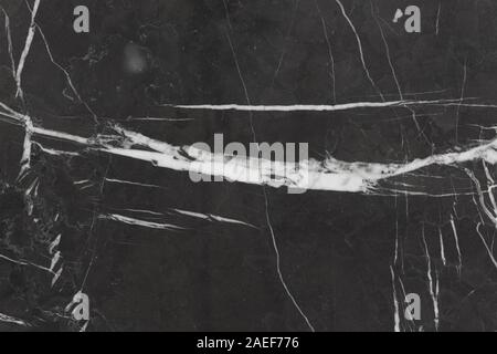 Close up of natural black marble stone background with white lines. Stock Photo