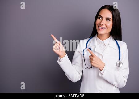 Close-up portrait of her she nice attractive lovely cute friendly cheerful brunet girl showing copy space professional medical expert clinic aid help Stock Photo