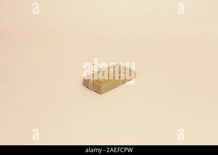A present in paper box, copy space. A gift wrapped in sustainable natural package in isolated background Stock Photo