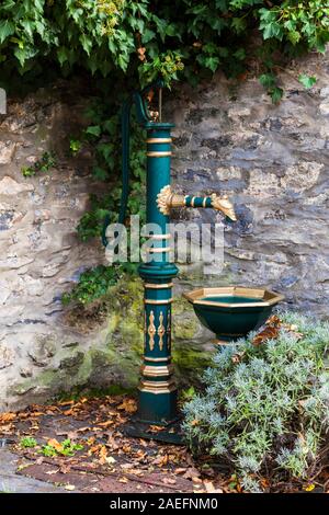 An antique cast iron water pump with a handle in the old town of Diez Stock Photo