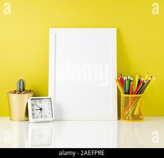 Mockup with clean white frame, colored pencils on bright yellow background. Concept for creativity, drawing. Stock Photo