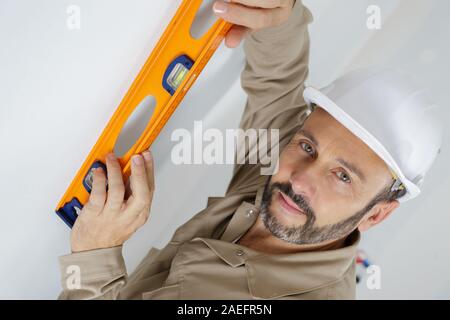 man posing with a builders level Stock Photo