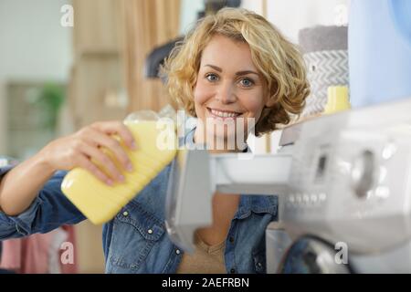 happy woman doing a laundry at home Stock Photo