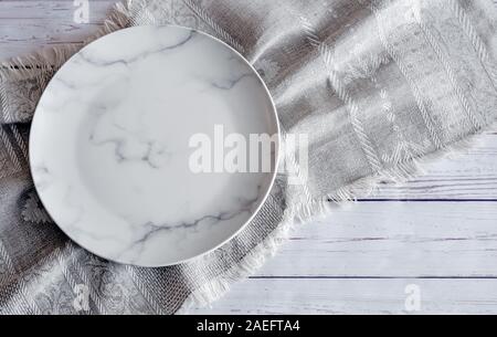 A white empty plate on a linen napkin Stock Photo