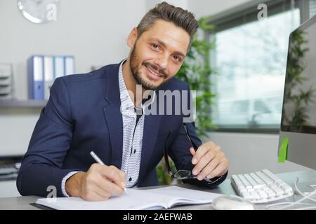 happy young business man portrait in bright modern office indoor Stock Photo