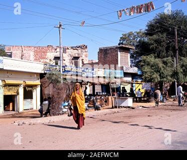 Indian woman walking along a village street, Jaipura, Rajasthan, India. Stock Photo